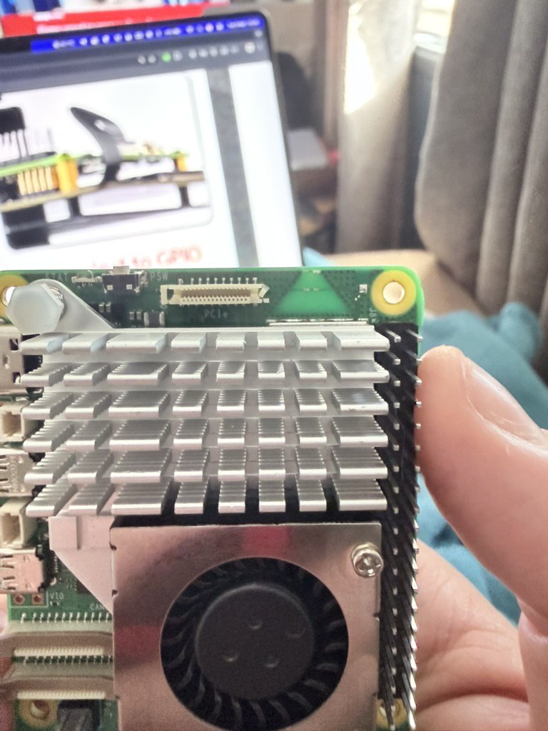 Raspberry Pi board with large heatsink and fan while preparing PCIe expansion.